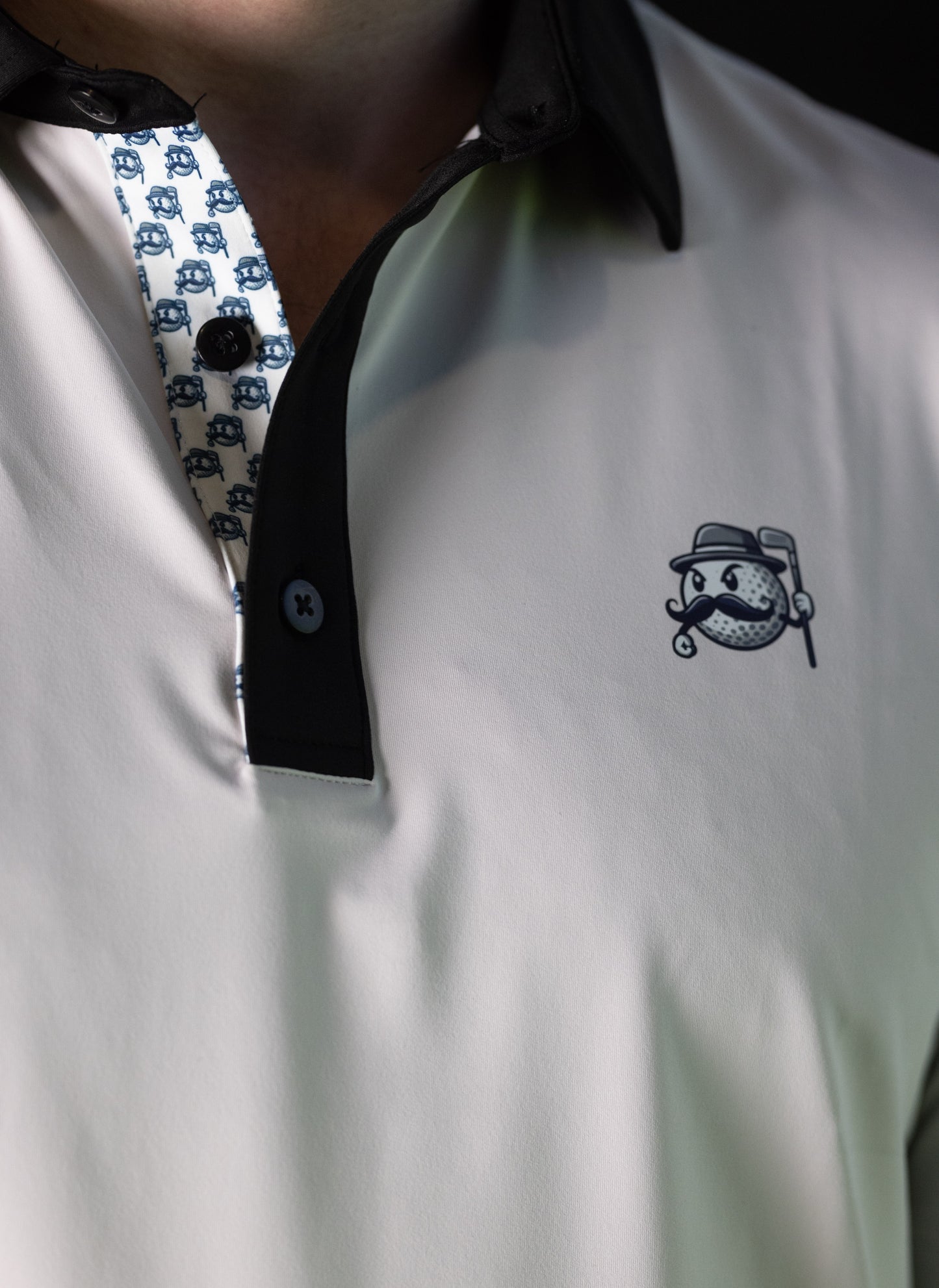 MLGN flagship polo featuring "Mully" direct to garment printed on left chest on a milk grey 3-button polo with custom button placket.